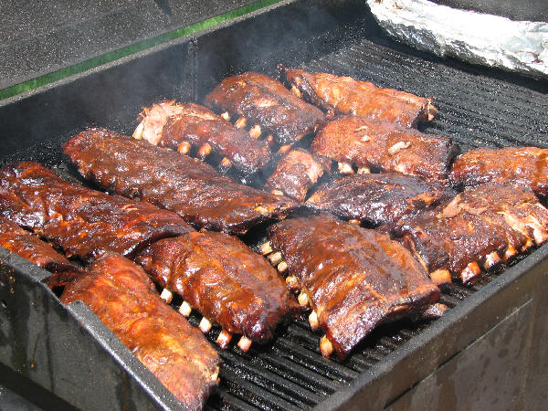 Sauced ribs finishing on charcoal grill