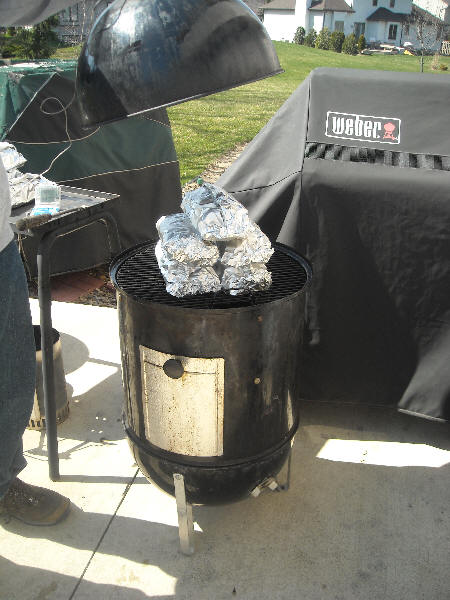 Foil wrapped ribs in smoker